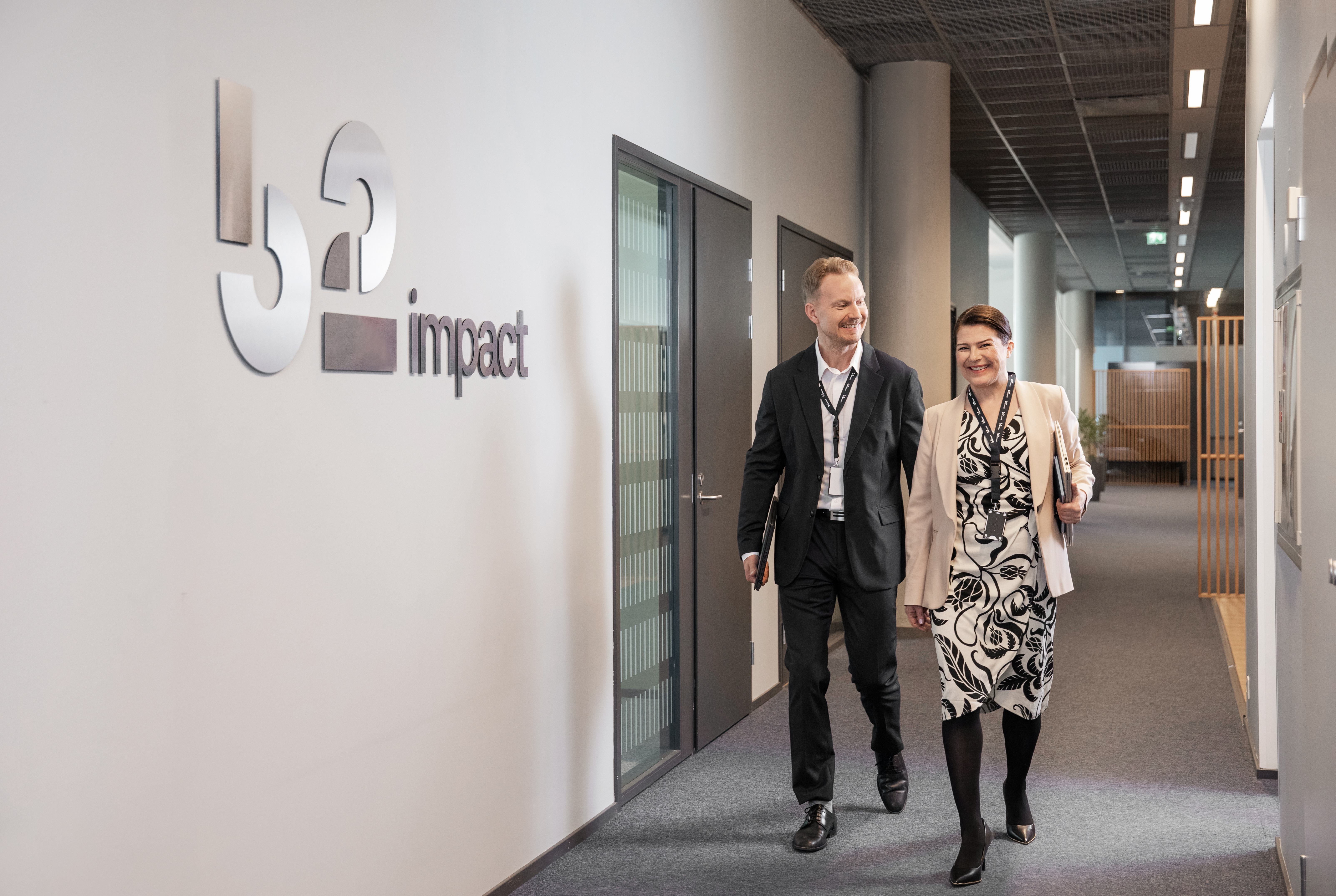 Man and woman walking in an office