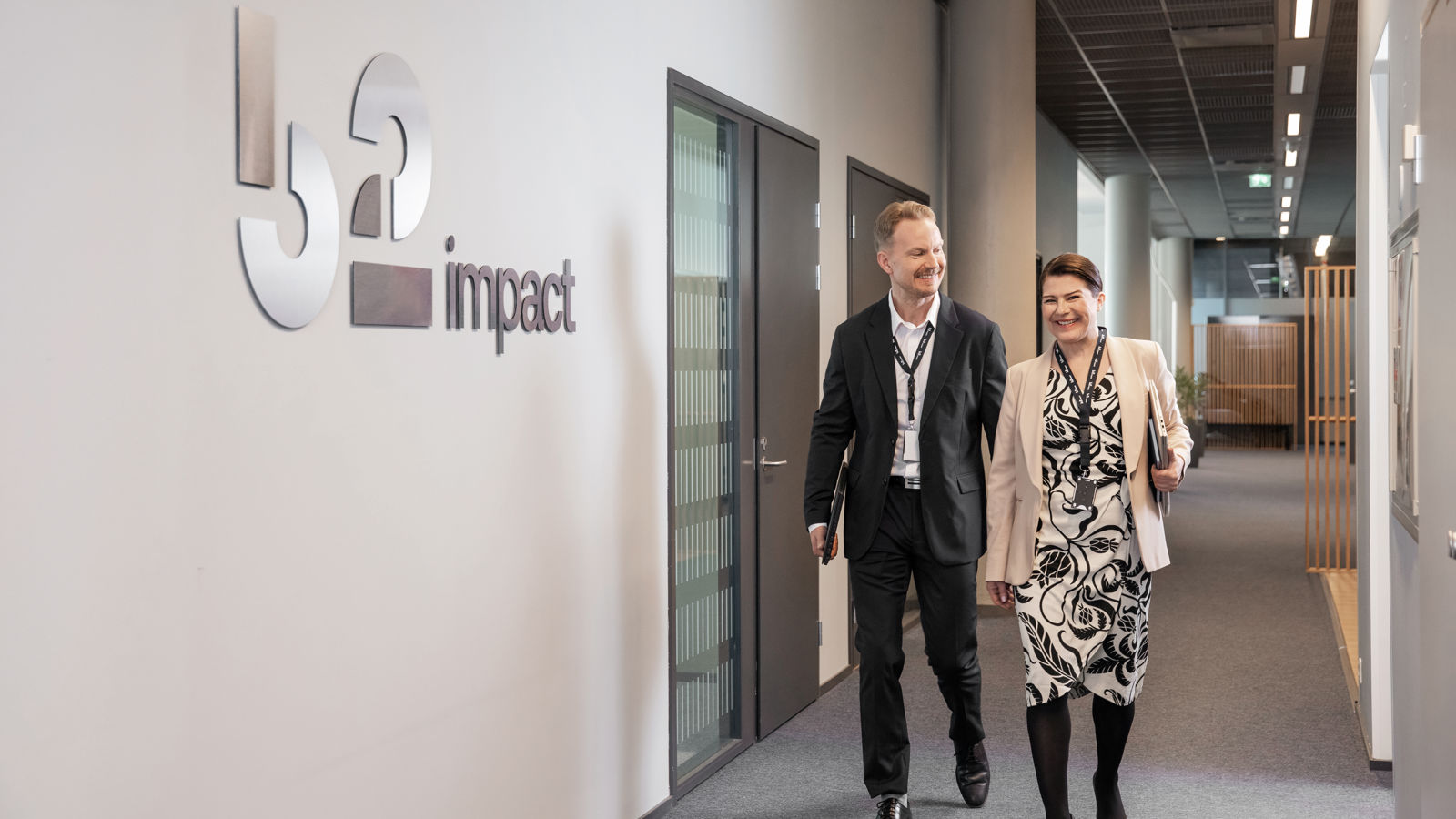 Man and woman walking in an office